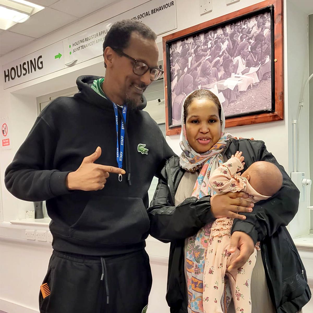 Daud supporting mother and infant at community centre